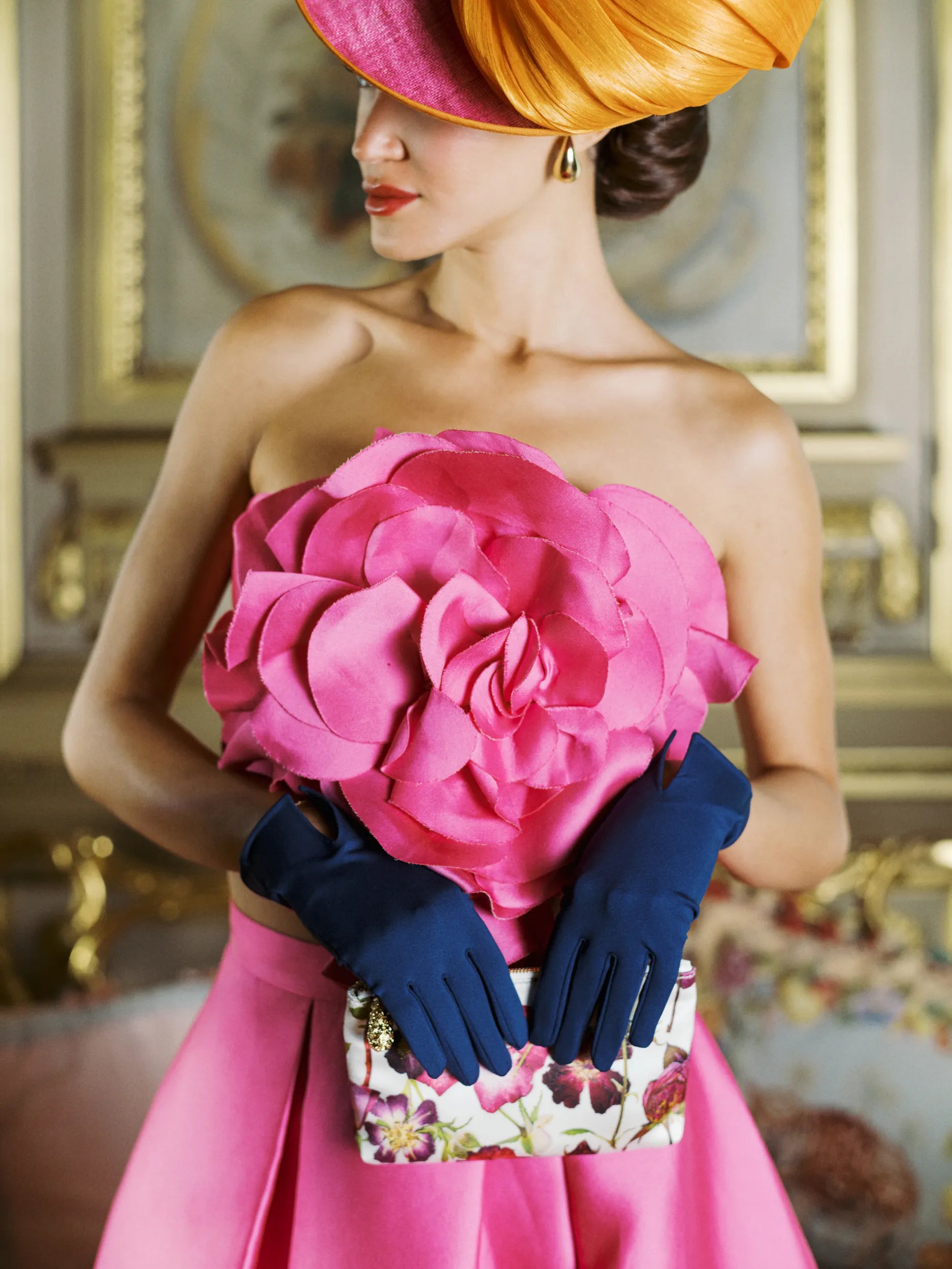 Woman holding pouch purse wearing ISABELLE wrist gloves in Parisian Blue.