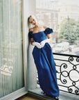 Women standing in blue formal dress wearing white THE JILL gloves.