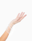 Womans hand wearing white tulle mid length ruched gloves.
