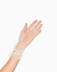 Womans hand wearing white tulle mid length ruched gloves.