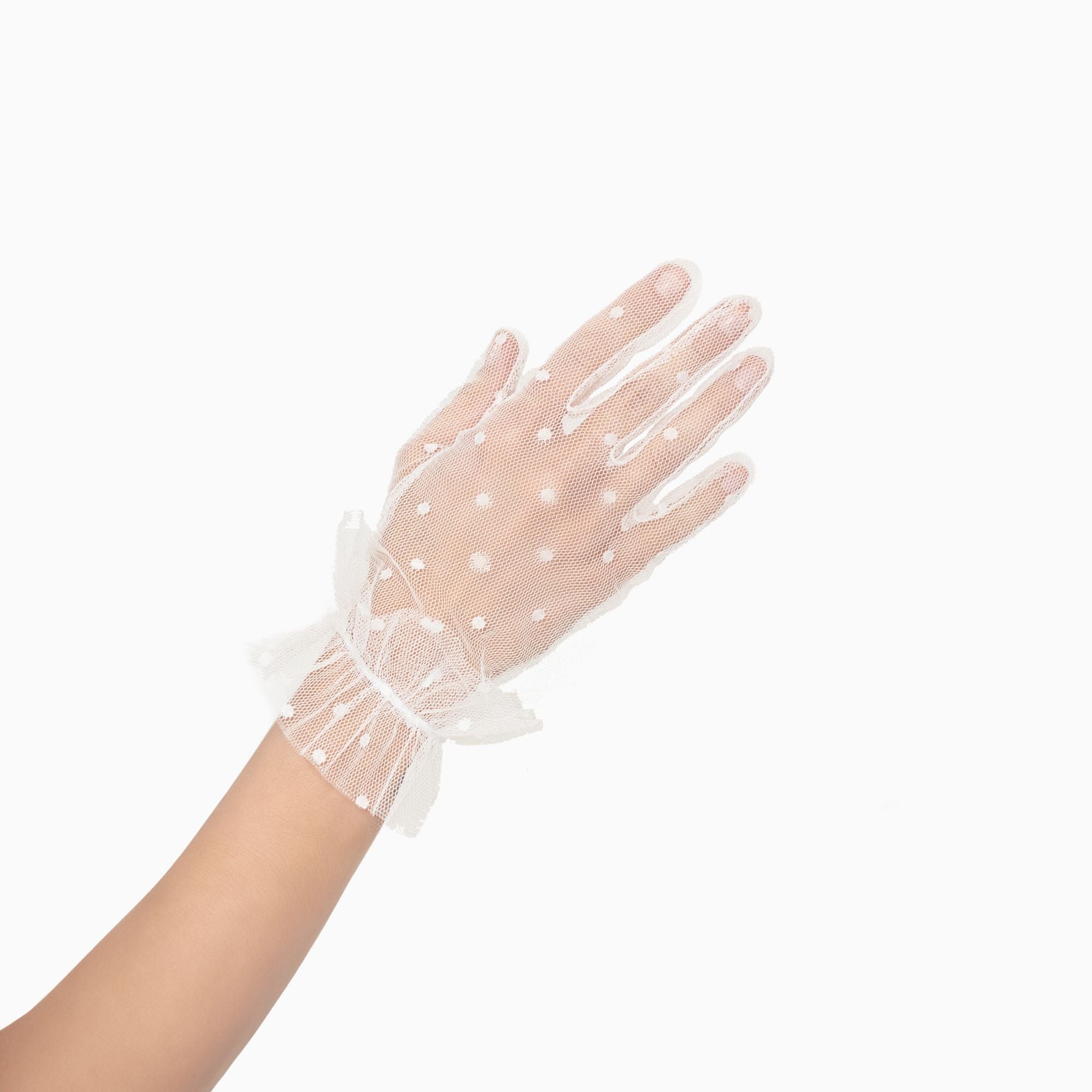 Woman wearing white tool, polkadot, wrist, length gloves