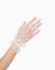 Woman wearing white tool, polkadot, wrist, length gloves