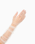 Woman's hand wearing elbow length ruched tulle white gloves.