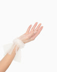 Women's hand wearing tulle white glove with ruched cuff