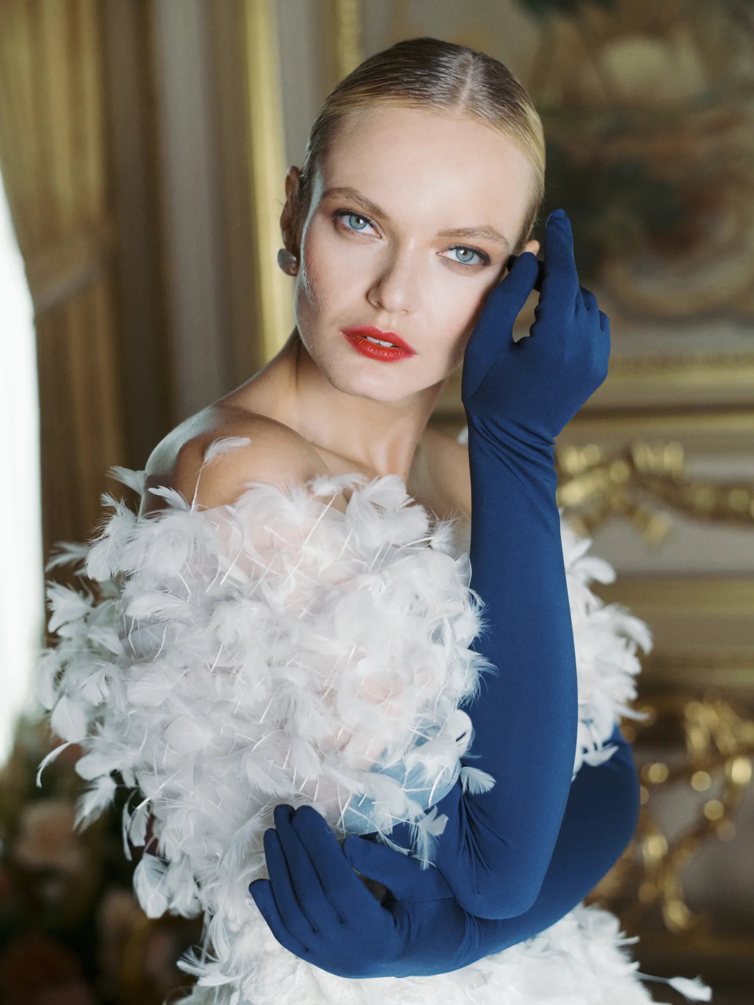 Glamorous woman wearing over the elbow blue opera gloves.
