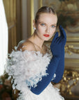 Glamorous woman wearing over the elbow blue opera gloves.