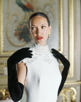 Bride elegantly posed wearing opera black velvet gloves.