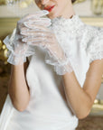Women playing with hands wearing white tulle polka dot golves.