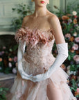 A woman in a pink dress with feathers and white gloves. She is wearing elegant over-the-elbow gloves, The Sunny - White Opera Gloves by LadyFinch, that perfectly complement her outfit, making her look even more stunning. These gloves are pure.