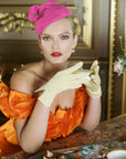 Elegant woman holding tea cup wearing THE ISABELLE wrist day gloves in yellow.