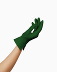 A woman's hand delicately holding THE ISABELLE - Green Day Glove - Holiday Edition by LadyFinch, perfect for spreading holiday cheer. These gloves are designed with touchscreen index fingers, ensuring convenience and functionality.