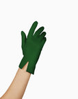 A woman spreading holiday cheer with THE ISABELLE - Green Day Glove - Holiday Edition gloves adorned with touchscreen index fingers by LadyFinch.