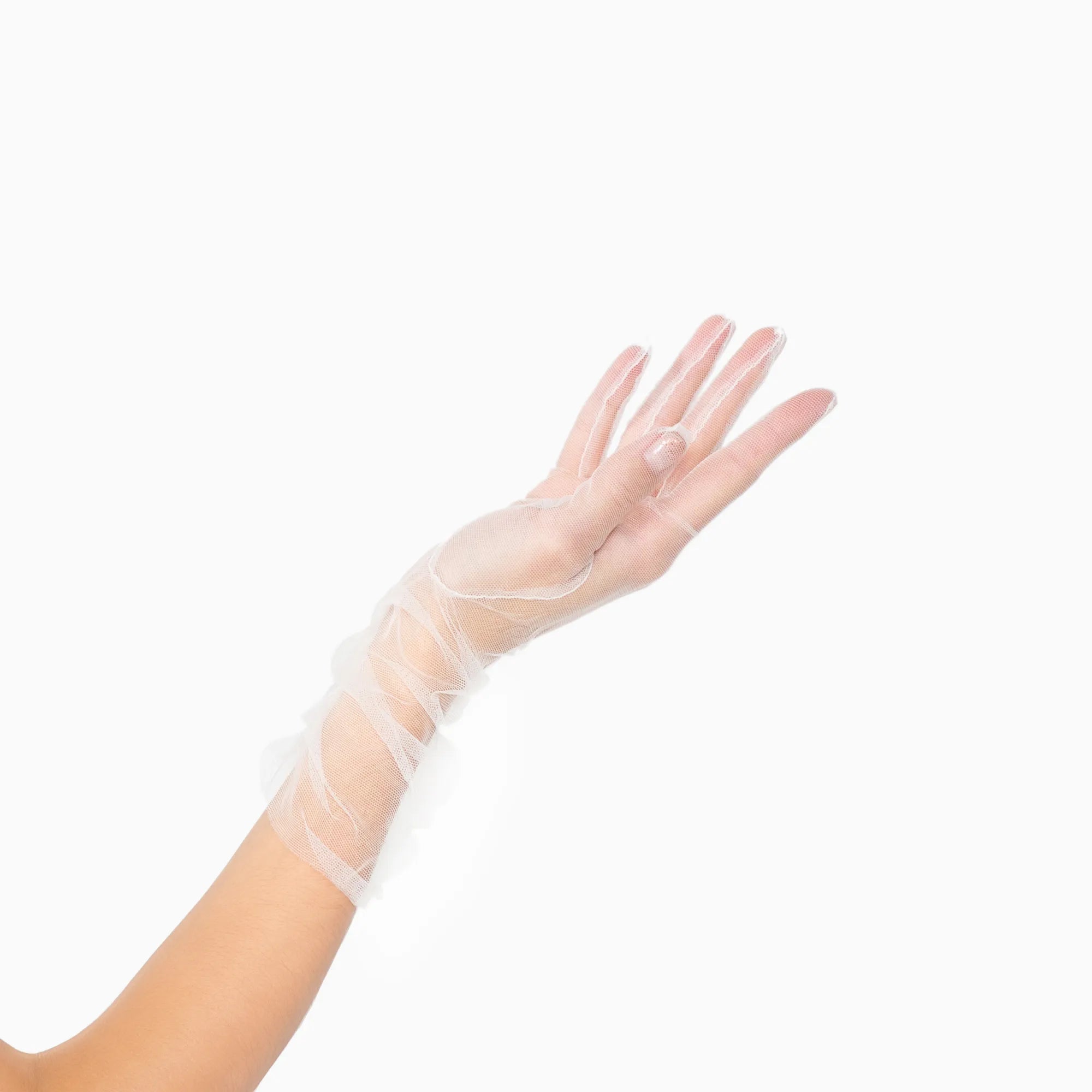 Womans hand wearing white tulle mid length ruched gloves.