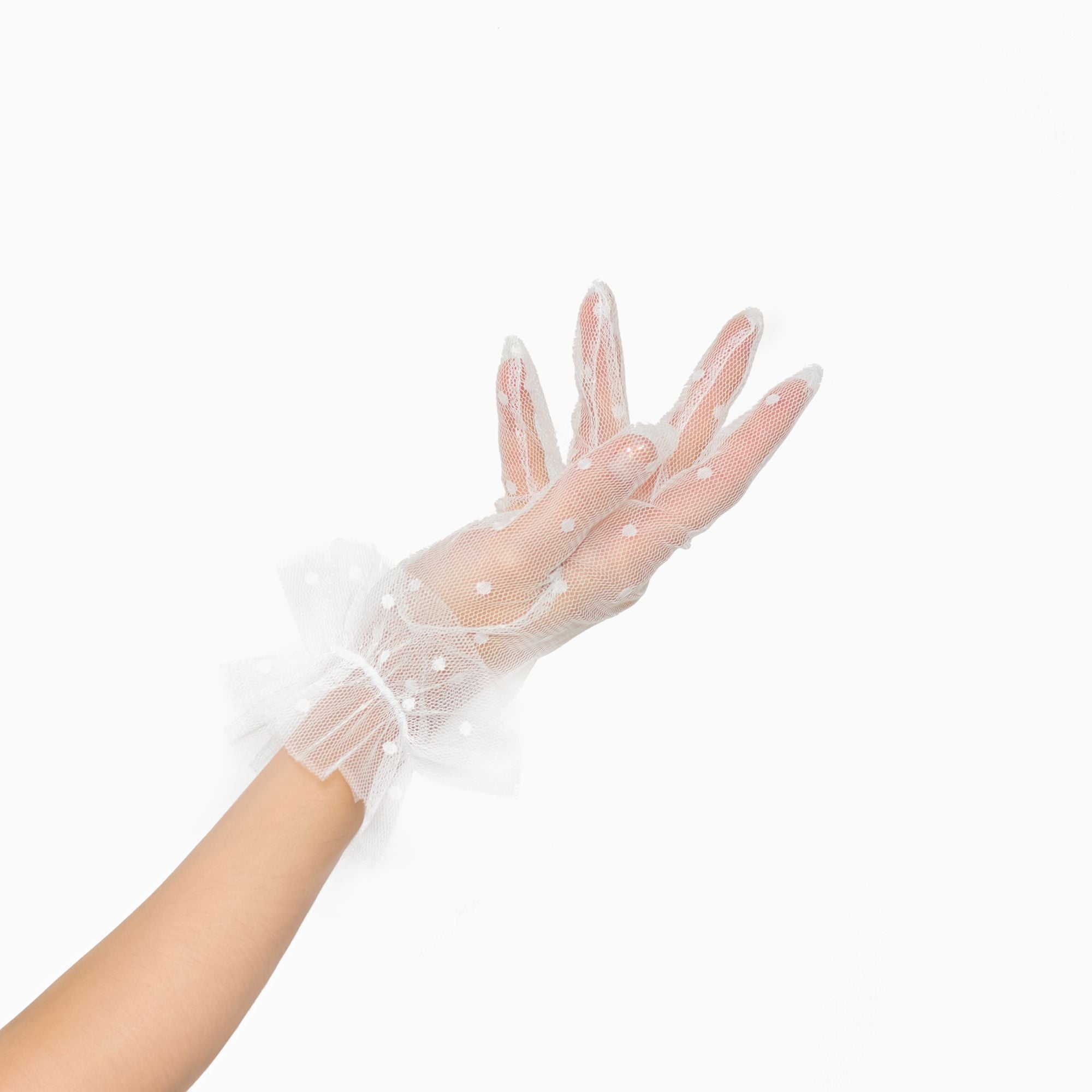 Woman wearing white tool, polkadot, wrist, length gloves