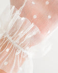 A close up of THE GEORGIA - White Polka Dot Tulle Gloves by LadyFinch.