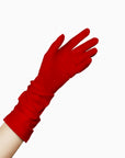 A woman's hand is holding THE JILL - Red Mid Length Glove - Holiday Edition by LadyFinch with ruched detailing.