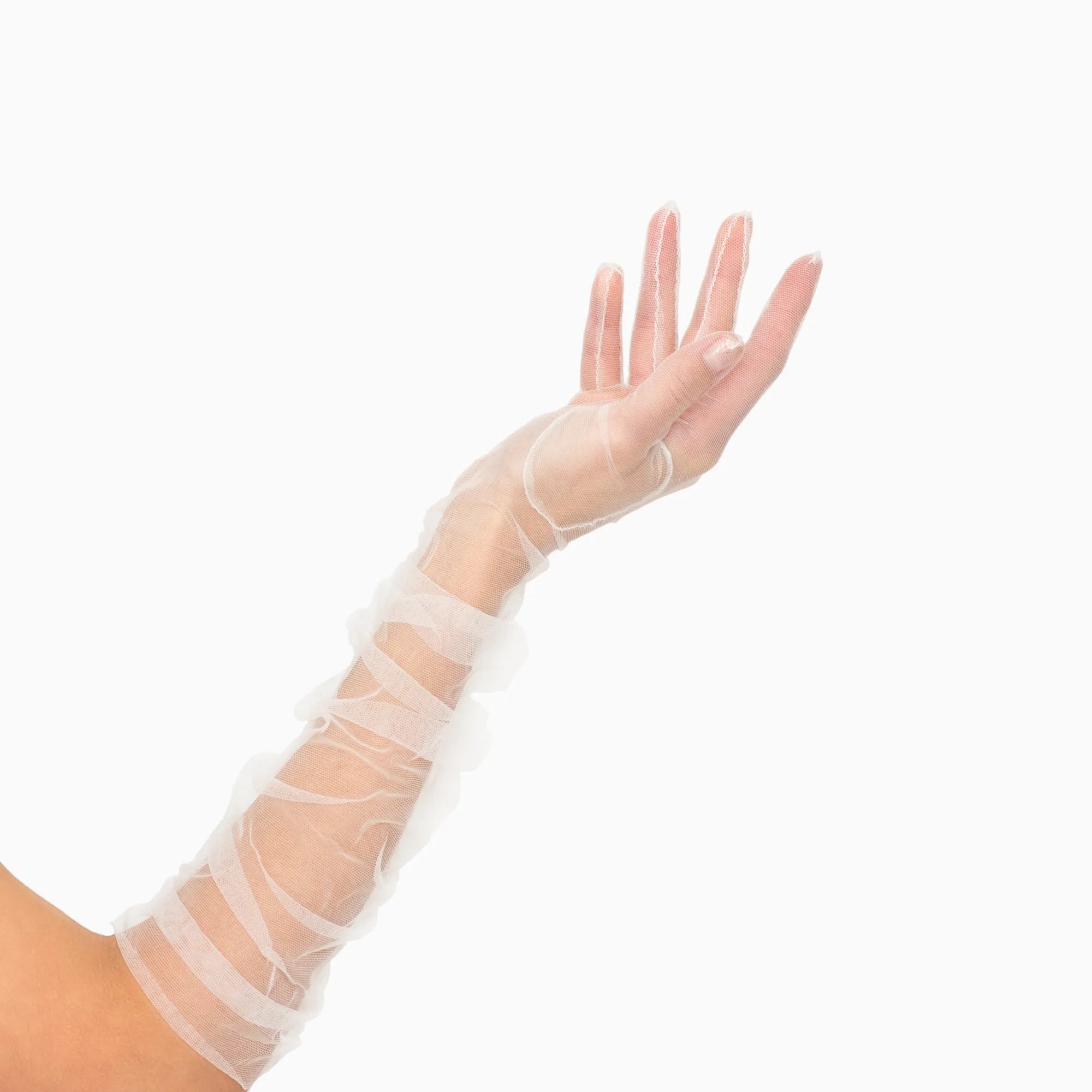 Woman&#39;s hand wearing elbow length ruched tulle white gloves.