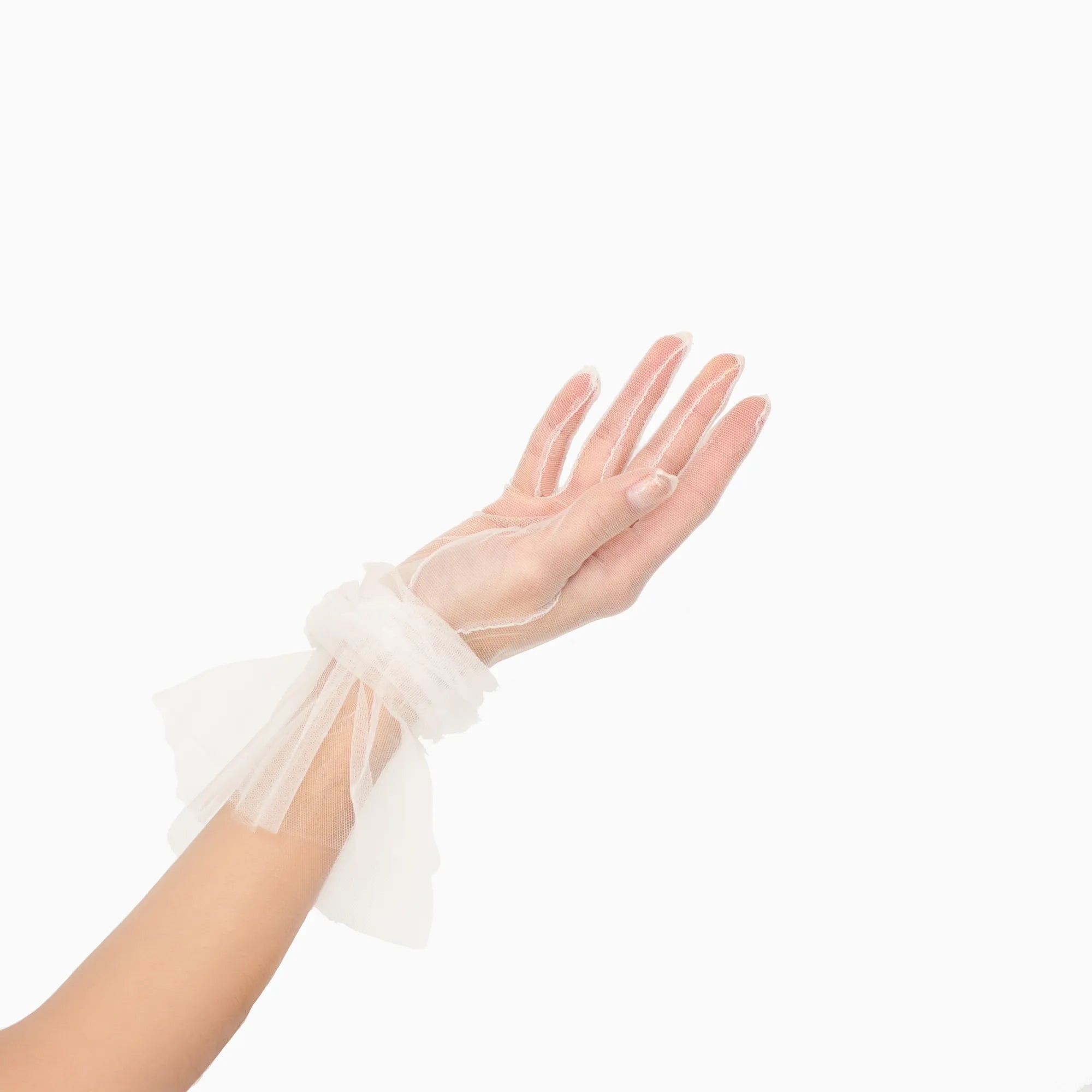 Women&#39;s hand wearing tulle white glove with ruched cuff
