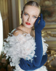 Glamorous woman wearing over the elbow blue opera gloves.