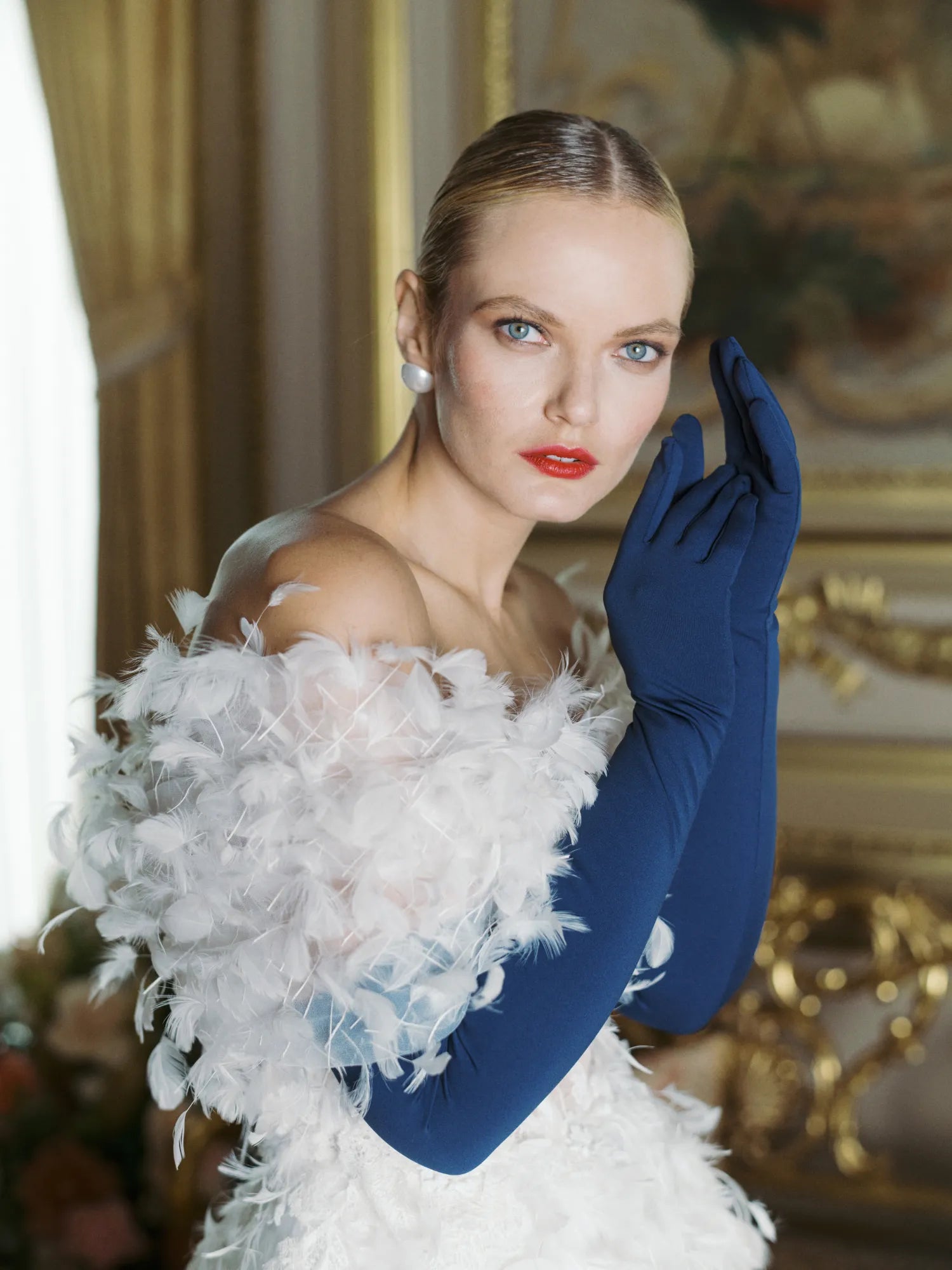 Glamorous woman wearing over the elbow blue opera gloves.