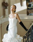 Bride standing on stairs wearing over the elbow, opera black velvet gloves.