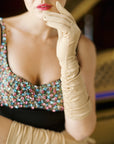 Elegant woman, wearing elbow length, long, beige gloves.